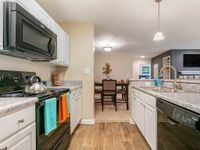 Gourmet kitchen with pendant lighting, wood flooring
