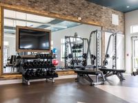 Interior fitness center, weight rack, squat rack, full wall mirror with warm backlighting
