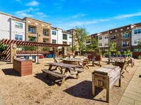 Outdoor kitchen and firepit with lots of sitting options.
