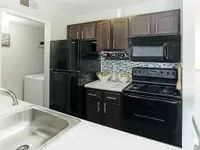 Experience the elegance of this contemporary kitchen, combining style with functionality.