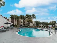 Experience serene poolside living with lush tropical scenery.
