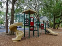 Enjoy family fun in this spacious playground nestled among verdant trees.