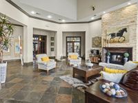 Luxurious lounge with modern furniture, stone fireplace, and stylish decor.
