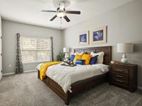 Elegant bedroom with a plush bed, modern decor, and inviting natural light.