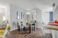 Chic dining area with modern decor, elegant table settings, and stylish bar seating in a bright, open-concept space.