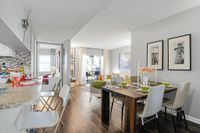 Bright modern apartment interior featuring a spacious open kitchen, cozy living area, and elegant dining setup with vibrant decor and natural light.