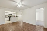 Inviting open-concept apartment with elegant hardwood floors, modern kitchen, and bright spacious rooms.