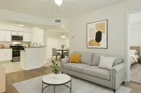 Contemporary open-concept living area with stylish kitchen and cozy seating, perfect for modern comfort and entertaining.