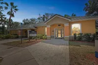Inviting leasing office exterior with palms and well-maintained landscape, welcoming you to your new home.