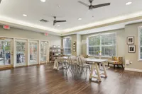 Bright and airy communal space with modern furniture, large windows, and chic decor, perfect for gatherings and relaxation.