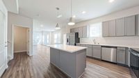 Kitchen featuring an island and stainless steel appliance package.