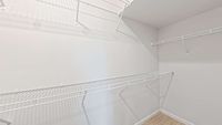 Bright, spacious closet featuring sleek white wire shelving for optimal storage solutions.