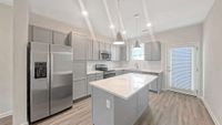 Designer kitchen with a full stainless appliance package.