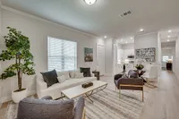 Luxe of Prosper | Apartments in McKinney | Rental in McKinney | Elegant open-plan apartment living room, cozy seating area, and bright kitchen.