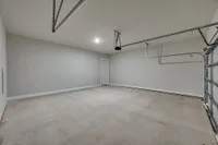 Luxe of Prosper | Apartments in McKinney | Rental in McKinney | Spacious and modern two-car garage with pristine walls and ample lighting, ideal for storage and parking.
