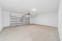 Spacious and clean two-car garage with sleek automatic door and ample lighting.