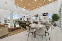 Luxurious open-concept lounge with chic seating, modern decor, and expansive windows providing stunning views.