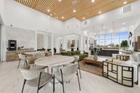 Elegant communal area with modern seating, sleek wooden ceiling, and abundant natural light from large windows.