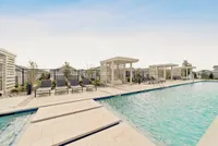 Elegant outdoor pool area with stylish cabanas and comfortable lounge chairs, perfect for relaxation and enjoying sunny days.