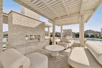 Luxurious outdoor lounge area with modern pergola, comfortable seating, and poolside views.