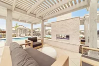 Covered backyard patio with seating at single-family rental home in Denton TX near Rayzor Ranch