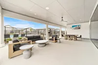 Elegant outdoor lounge area with modern seating and poolside views, perfect for relaxation or entertaining.
