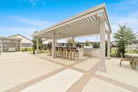 Outdoor lounge and grilling area at rental home community in Denton TX near Rayzor Ranch
