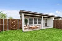 Private fenced backyard with covered porch at rental home in Denton TX near Rayzor Ranch