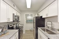 Kitchen with granite counters, stainless appliances, and modern cabinetry