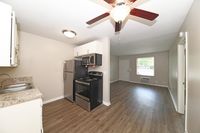 Kitchen area with stainless appliances and hardwood-style flooring
