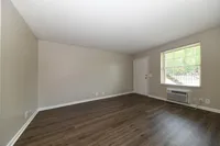 Spacious living room with hardwood-style flooring