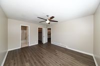 Spacious bedroom with hardwood-style flooring