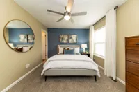 Cozy bedroom with carpet and ceiling fan