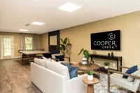 Spacious living room with hardwood-style flooring and built-in lighting