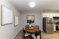 Dining area with hardwood-style flooring and overhead lighting Apartments in Piedmont