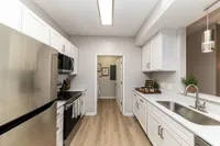 Kitchen with quartz counters, modern cabinetry, & hardwood-style flooring Apartments in Piedmont