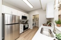 Kitchen with quartz counters, modern cabinetry, & stainless appliances Apartments in Piedmont
