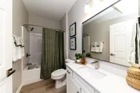 Bright bathroom with quartz counters and bathtub Apartments in Piedmont