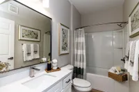 Bright bathroom with quartz counters, high-rise faucets & bathtub Apartments in Piedmont
