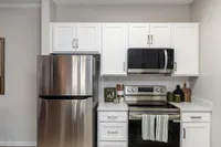 Kitchen with modern cabinetry & stainless appliances Apartments in Piedmont