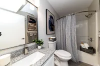 Bathroom with granite counters and high rise faucet Apartments in Piedmont