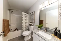 Bathroom with granite counters and bathtub Apartments in Piedmont