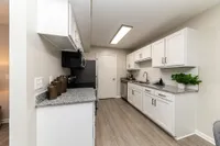 Kitchen with granite counters and modern cabinetry Apartments in Piedmont