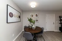 Dining area with hardwood-style flooring and overhead lighting Apartments in Piedmont
