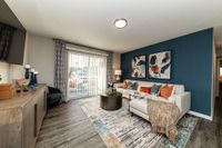 Spacious living room with hardwood-style flooring & overhead lighting