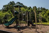 Explore this delightful playground nestled in a verdant setting, perfect for kids' adventures.