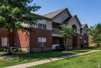 Explore the charming exterior of this contemporary apartment, offering a harmonious blend of style and nature.