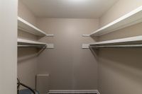 Maximize your organization with this expansive walk-in closet, complete with extensive shelving.