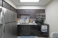 Experience culinary elegance in this modern kitchen, equipped with top-quality appliances and stylish finishes.