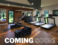 Coming Soon to Slates at Powdersville Modern fitness center with treadmills, weight benches, and a sleek wooden interior, coming soon for an invigorating workout experience.